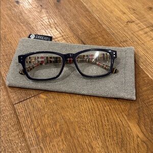 Corinne McCormack Edie 2.0 Navy and Striped Reading Glasses and hinge case.
